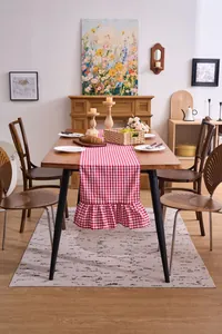 Rustic red checkered table runner with double ruffles in a cozy dining room