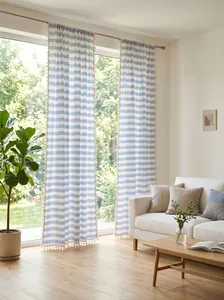 Detailed view of blue and white striped tassels curtains in a bright living room