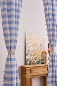 Close-up of American vintage blue striped curtains with decorative tassels