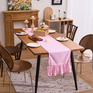 Pink and white checkered cotton linen table runner with elegant ruffled edges for dining