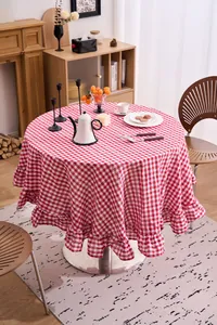 Close-up detail of a French vintage red and white checkered round tablecloth with ruffles