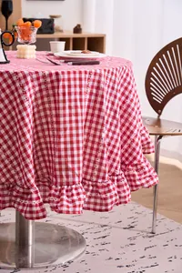 Close-up showing the detail of a red and white checkered round tablecloth with ruffles