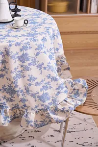 Close-up detail of French vintage floral print round tablecloth featuring elegant ruffled edges