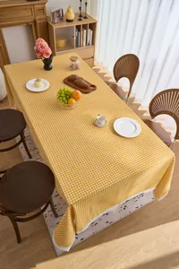 Yellow and white gingham tablecloth with delicate white lace trim for dining room decor