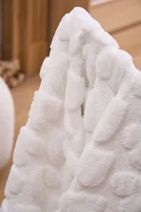 Detailed macro view of the embossed heart pattern on soft white carved fleece blanket