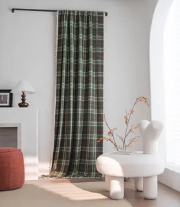 Full-length view of a green and brown plaid wool curtain in a minimalist interior scene.