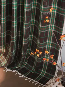 Detail of French plaid woolen curtain with classic green and brown checkered pattern