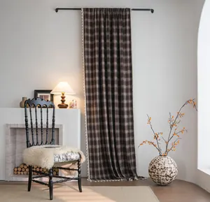 French vintage dark brown plaid curtain with white tassels displayed in cozy home setting