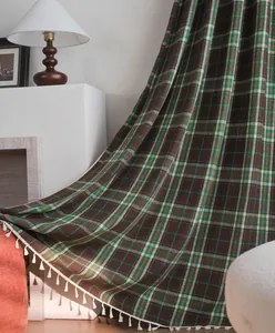 Detailed view of French plaid wool curtain featuring elegant white tassel fringe accents.