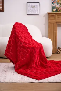 Detail view of bright red faux fur blanket with carved geometric star pattern texture