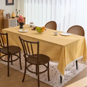 Yellow and white gingham rectangular tablecloth with lace trim for farmhouse kitchen decor.