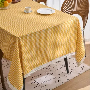 Pastoral yellow and white checkered tablecloth with elegant lace trim for home dining.