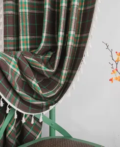 Macro detail shot of French plaid wool-like curtain featuring elegant white fringe tassels