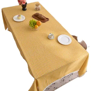 Yellow and white gingham checkered tablecloth with delicate lace trim for home decor