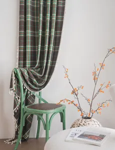French vintage plaid curtain with white fringe tassels in a cozy home setting
