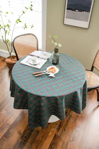 Green and red plaid round tablecloth in a cozy home setting with natural light.