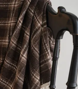 Close-up of coffee brown checkered French curtain fabric draped on a chair