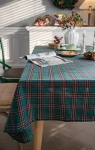 Green tartan plaid rectangular tablecloth in a cozy rustic dining room setting