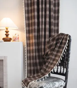 Detailed view of French coffee plaid curtain with white tassel fringe and semi-blackout fabric
