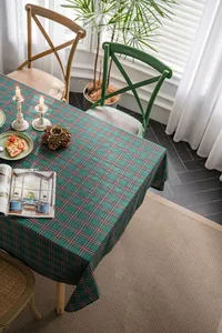 Green plaid Christmas tablecloth laid on a table in a cozy American cottage dining room