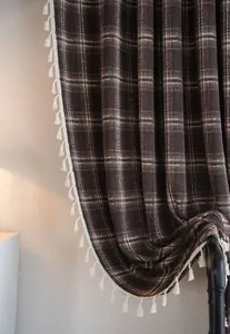 Close-up of coffee brown plaid French curtain with elegant white tassel fringe trim