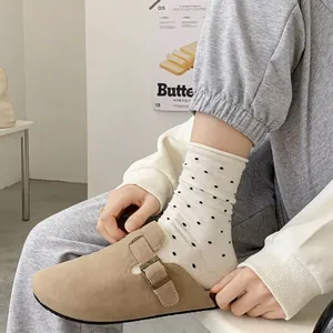 Cream white women's mid-calf cotton socks featuring a minimalist black polka dot pattern