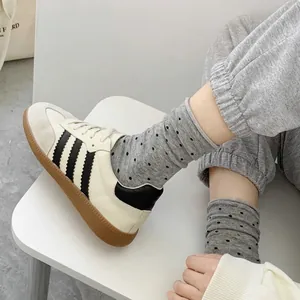 Grey polka dot cotton crew socks with rolled edges for women in casual style