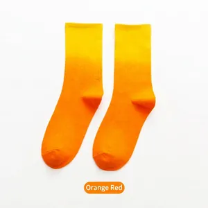 Vibrant orange and yellow gradient dip-dye crew socks for sports and skating fashion