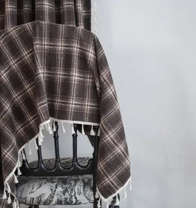 Macro view of French retro brown plaid curtain with elegant white tassel fringe
