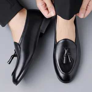 Classic black men's tassel loafers in British style, elegant slip-on leather dress shoes
