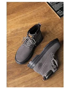 Macro view of grey suede work boots with durable rubber sole and lace-up design