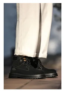Close-up of men's black suede Martin boots with lace-up detail and thick rubber soles.