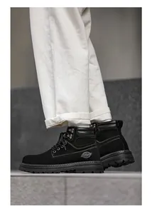 Close-up of premium black suede Martin boots for men paired with casual white trousers