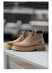 Detailed side view of tan suede men's work boots with durable rubber soles and laces