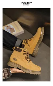 Detailed view of classic yellow men's work boots with durable rubber sole and lace-up design