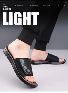 Close-up of black men's casual sliders with checkerboard pattern on the strap