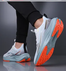 Detail view showing the textured orange anti-slip sole of stylish men's mesh running shoes