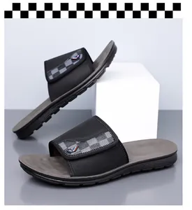 Stylish men's black slide sandals with grey checkerboard strap pattern for summer leisure.