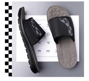 Overhead view of men's non-slip casual slides with textured black strap and grey footbed