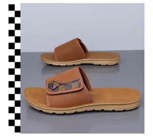 Macro detail of brown men's casual sliders featuring checkerboard pattern and non-slip sole
