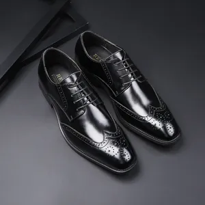 Classic men's black leather Brogue dress shoes with decorative perforations and laces