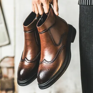 Vintage brown leather brogue wingtip boots for men with classic pointed toe design