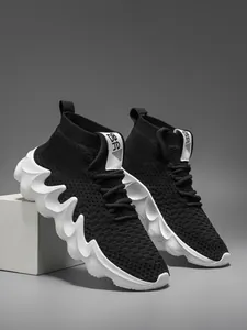 Close-up of black breathable knit sneakers with unique wavy thick white soles
