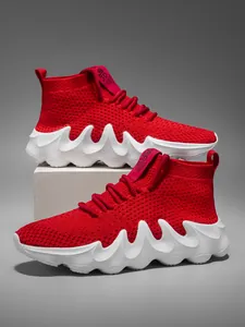 Detail view of red high-top breathable flyknit sneakers featuring unique white wavy soles