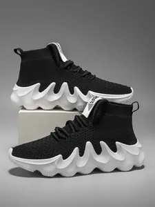 Side detail of men's breathable high-top knit sneakers with unique wavy thick white sole