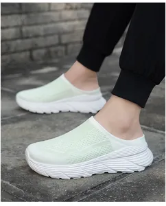 Close-up of breathable mesh upper and thick white sole on light green mule sneakers