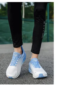 Close-up of white and light blue breathable men's running shoes worn for training