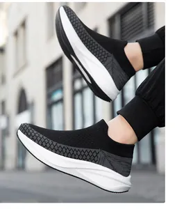 Close-up of black fly-knit sock sneakers showing the textured mesh and white contoured sole