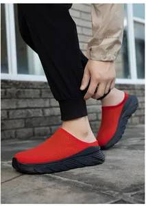 Close-up of red breathable mesh slip-on mules with thick black soles for outdoor use.