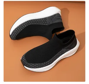 Close-up detail showing the breathable black fly-knit mesh texture on slip-on sock sneakers